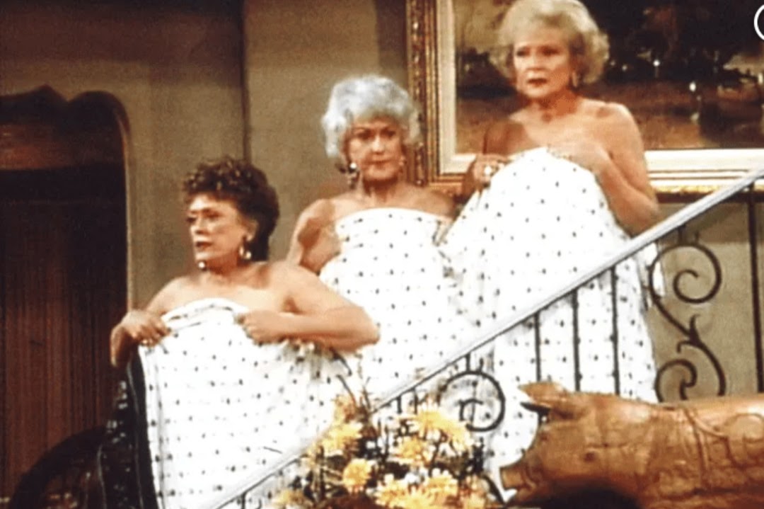 The girls half naked hiding behind a sheet